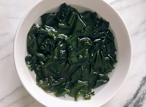 rehydrated wakame seaweed in a bowl by thewoksoflife.com