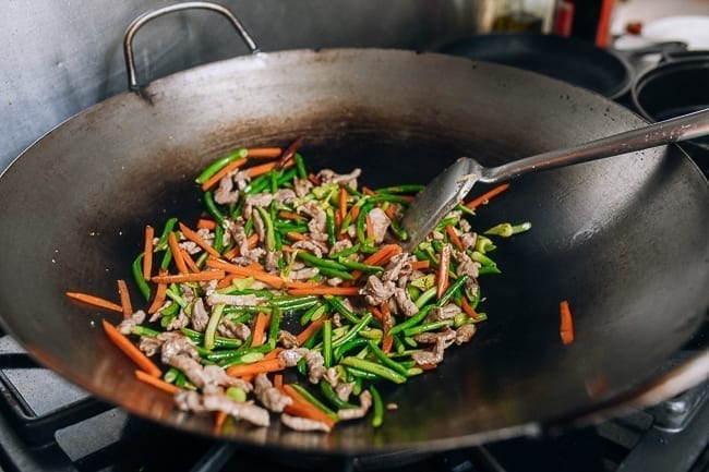 Stir-frying garlic scapes with pork