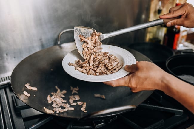 Removing pork from wok