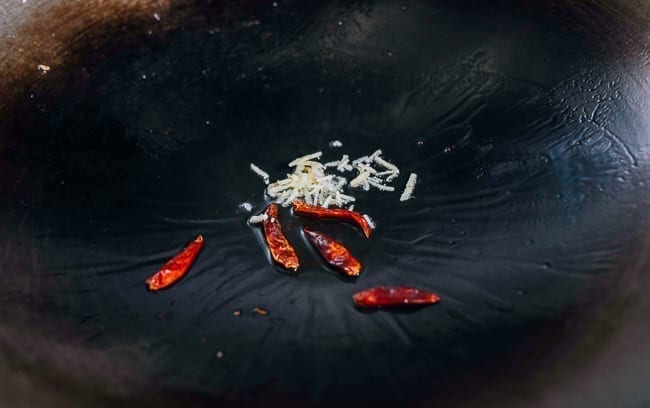 Dried chilies and ginger in wok