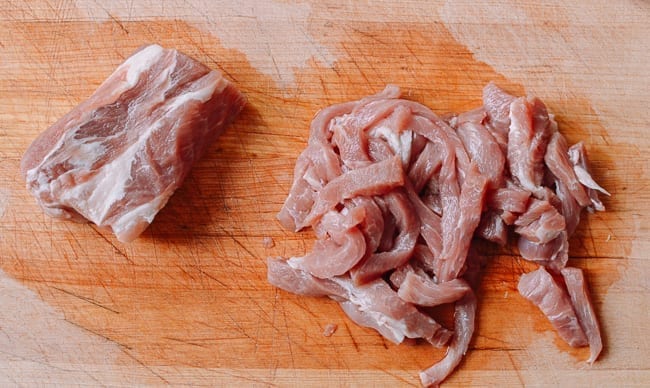 Cutting pork into thin strips