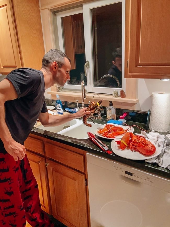 Justin holding fresh lobsters, thewoksoflife.com