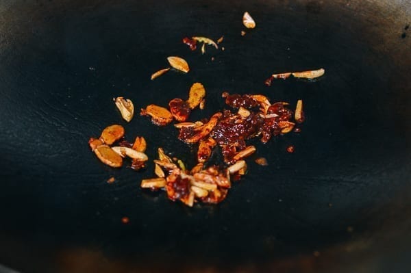 Frying spicy bean sauce with ginger and garlic, thewoksoflife.com