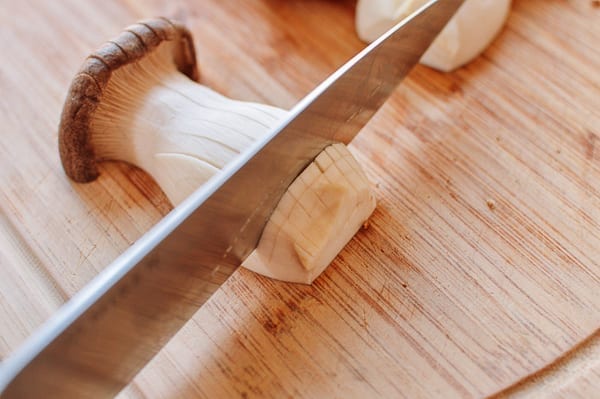 Scoring king oyster mushroom with knife, thewoksoflife.com