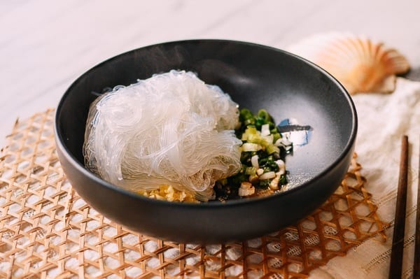Adding cooked glass noodles to serving dish, thewoksoflife.com