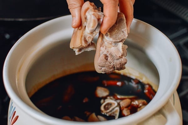 Adding pork trotters to vinegar and ginger, thewoksoflife.com