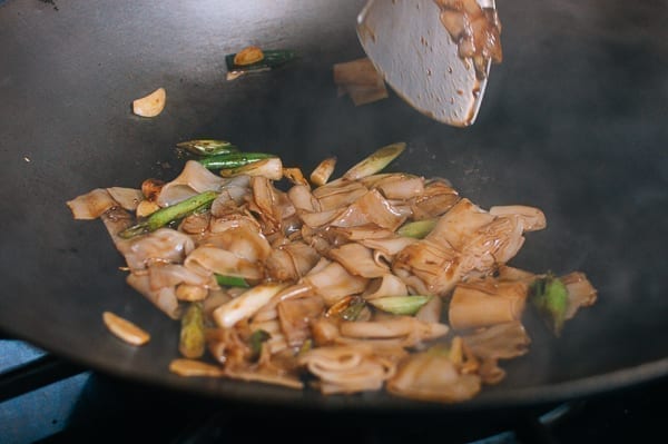 Stir-frying noodles in soy sauce mixture, thewoksoflife.com