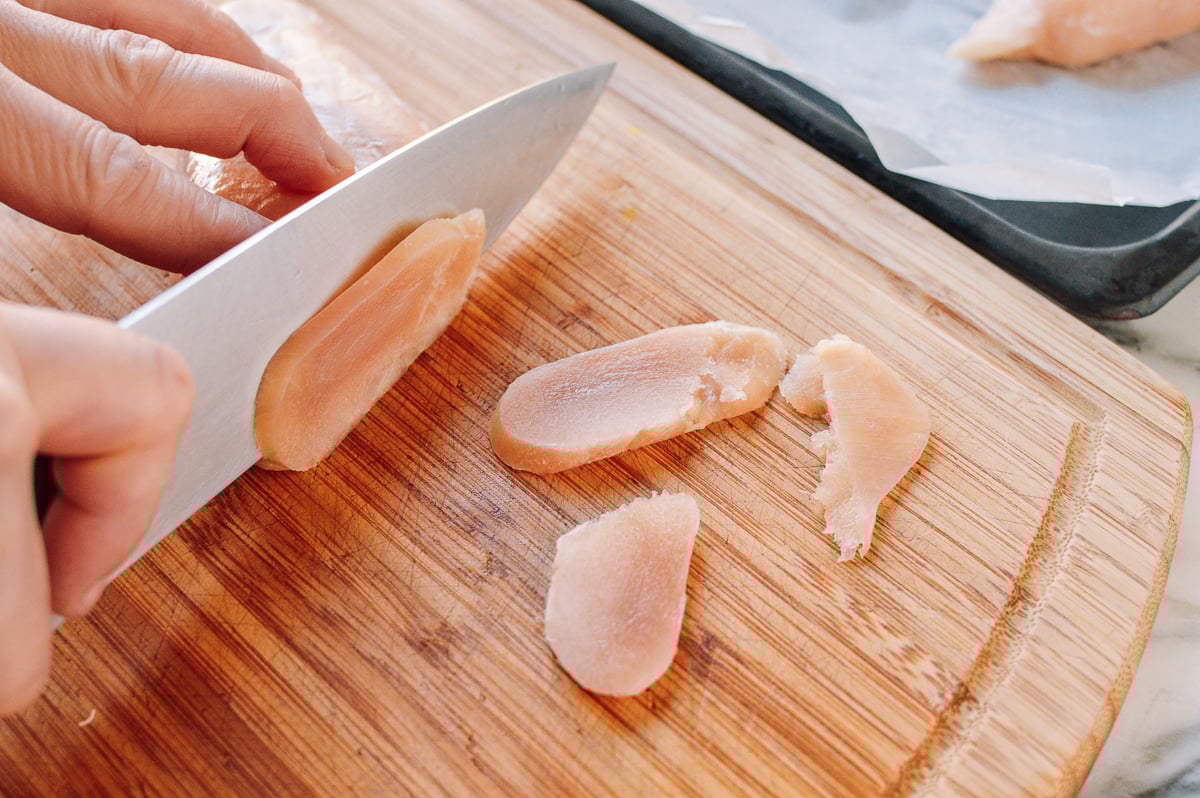 Slicing partially frozen chicken breast, thewoksoflife.com