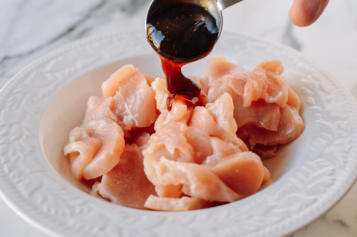 Adding oyster sauce to chicken marinade, thewoksoflife.com