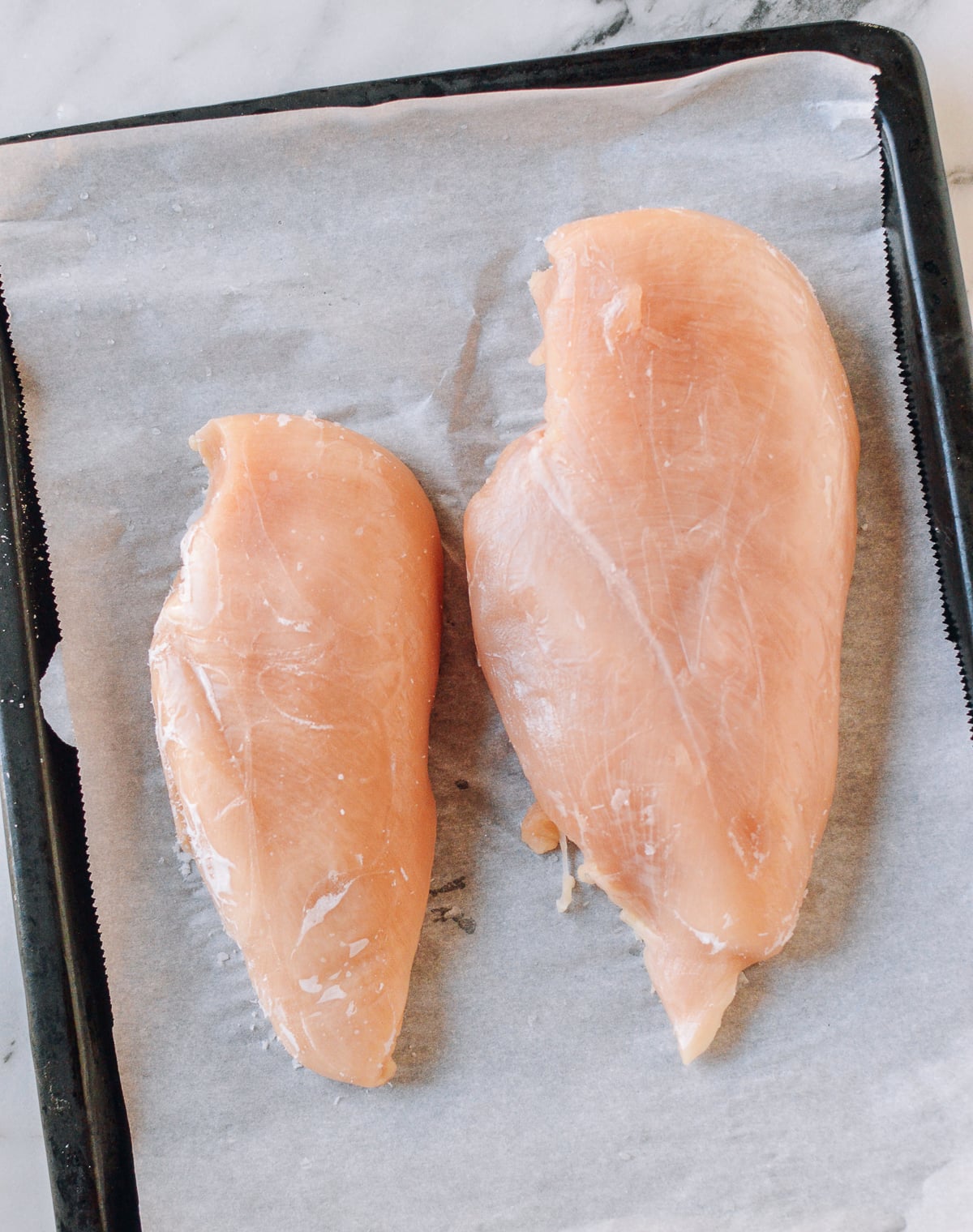 Partially frozen chicken breasts, thewoksoflife.com