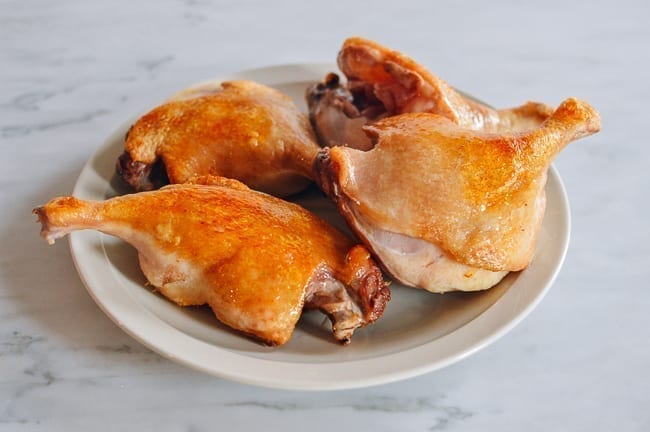 Seared duck legs on plate, thewoksoflife.com