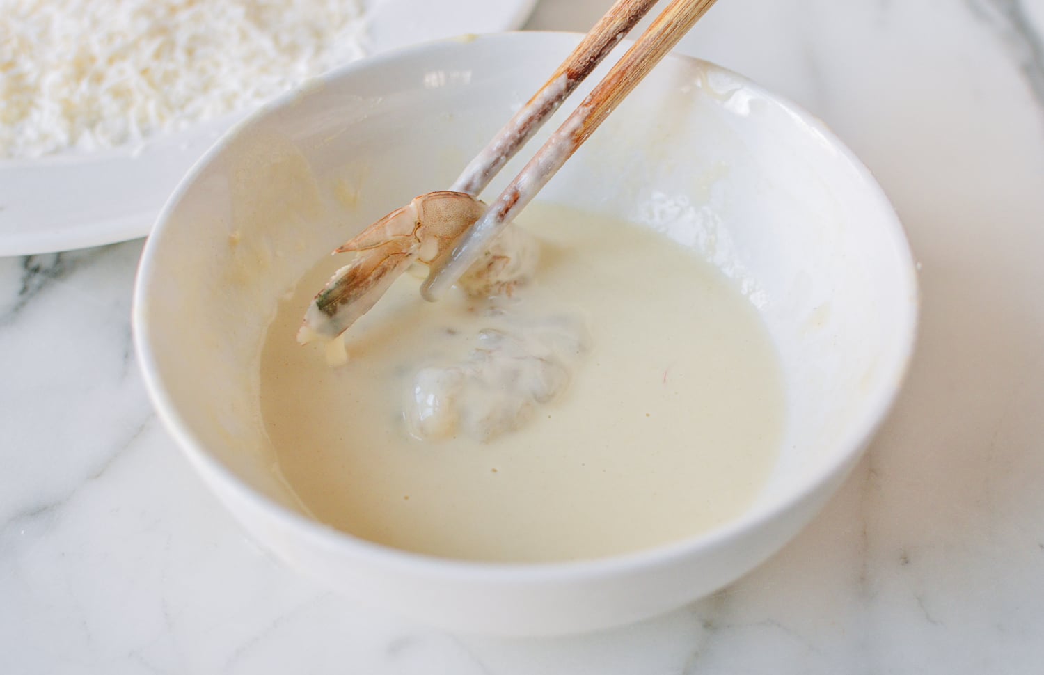 Dipping shrimp in batter, thewoksoflife.com