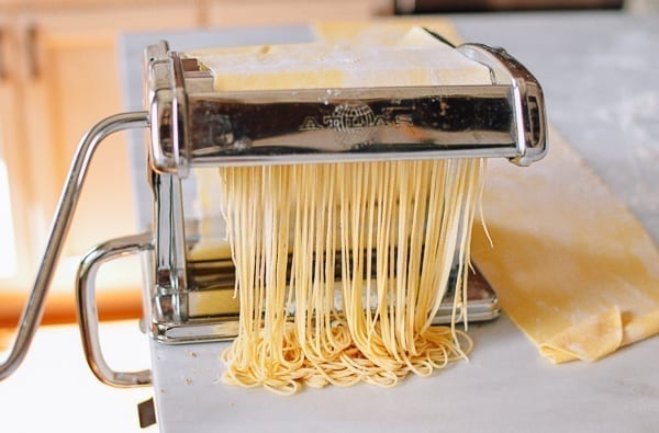 Cutting thin noodles with pasta roller, thewoksoflife.com