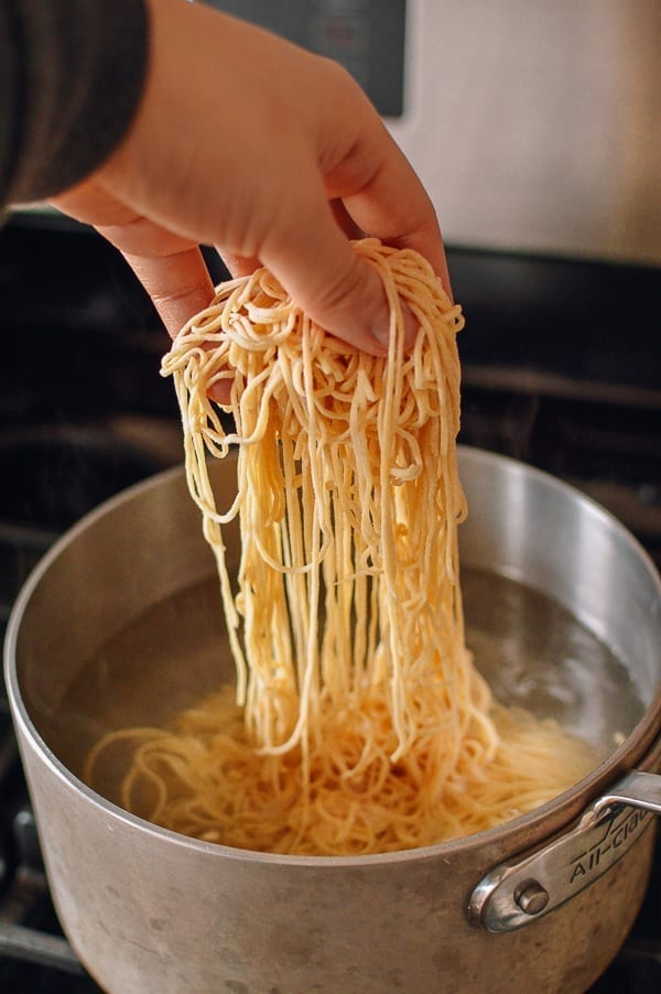 Adding noodles to boiling water, thewoksoflife.com