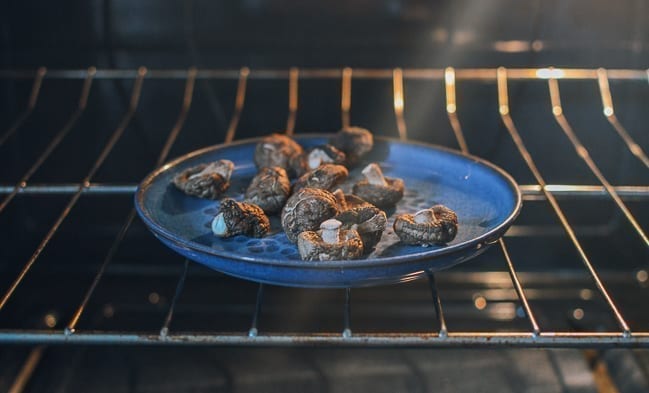 Putting mushrooms in oven to dry, thewoksoflife.com
