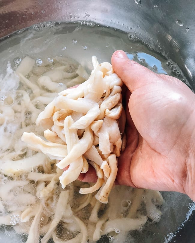 Washing the dried daikon pieces, thewoksoflife.com