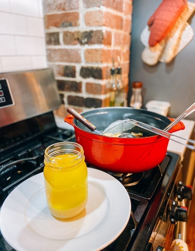Straining rendered duck fat into a jar, thewoksoflife.com