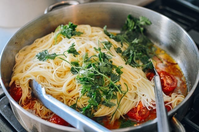 Tossing together slow roasted tomato pasta, thewoksoflife.com