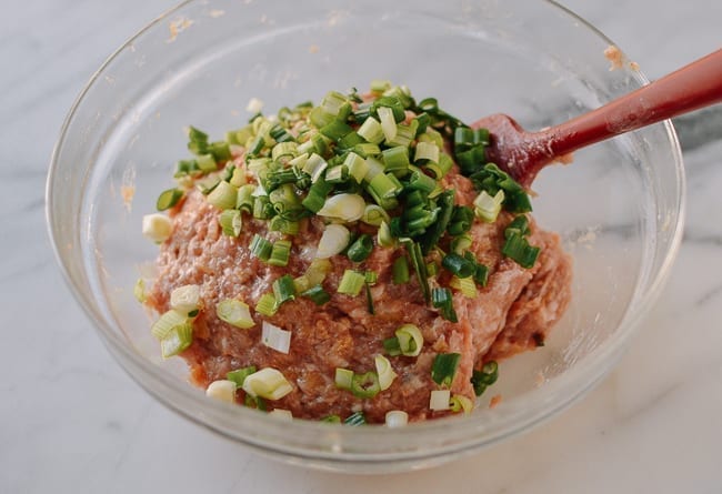 Stirring scallions into meat mixture, thewoksoflife.com