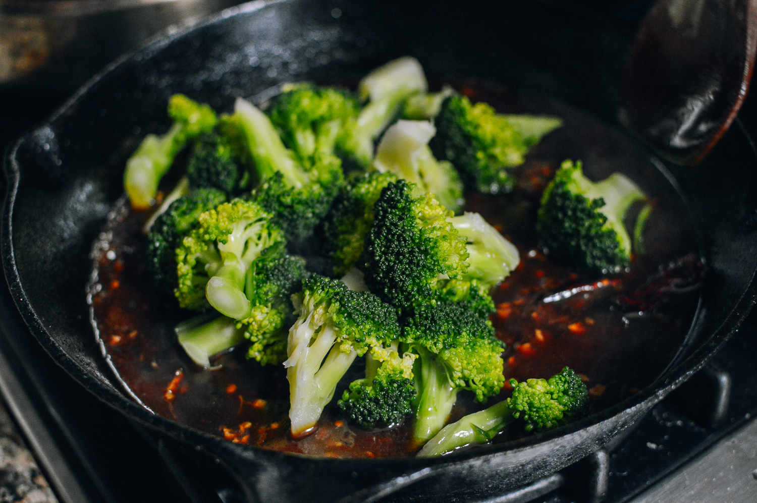 Adding broccoli to sauce, thewoksoflife.com