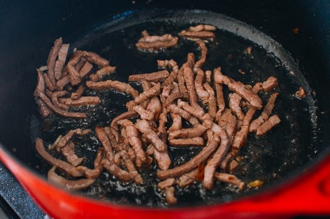 Browning strips of pork, thewoksoflife.com