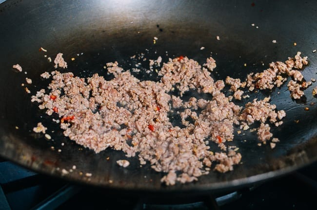 Browning pork in the wok, thewoksoflife.com