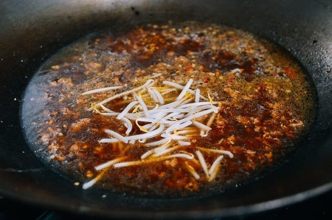 Adding bean sprouts to soup, thewoksoflife.com