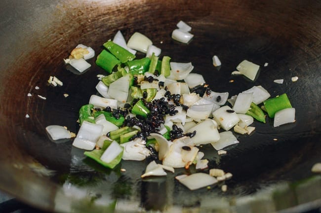 Onions, peppers, black beans in wok, thewoksoflife.com