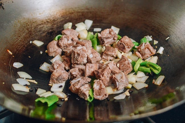 Adding pork ribs to wok, thewoksoflife.com
