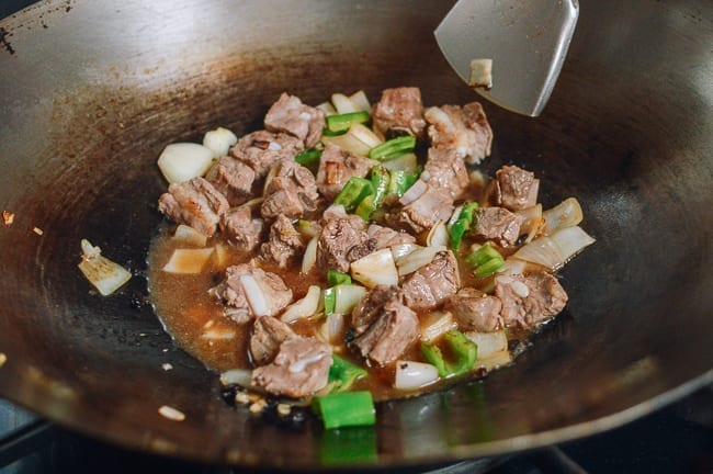 Simmering pork ribs in black bean sauce, thewoksoflife.com