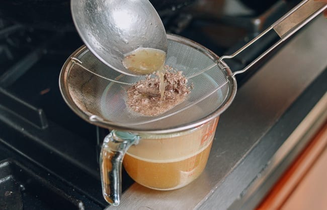 Straining pork stock, thewoksoflife.com