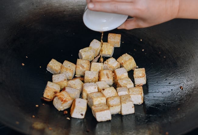 Adding Shaoxing wine to tofu, thewoksoflife.com