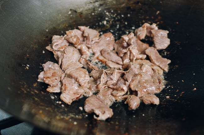 Searing pork slices in wok, thewoksoflife.com