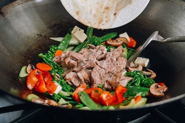 Adding pork back to wok, thewoksoflife.com