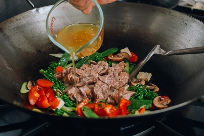 Adding stir-fry sauce, thewoksoflife.com