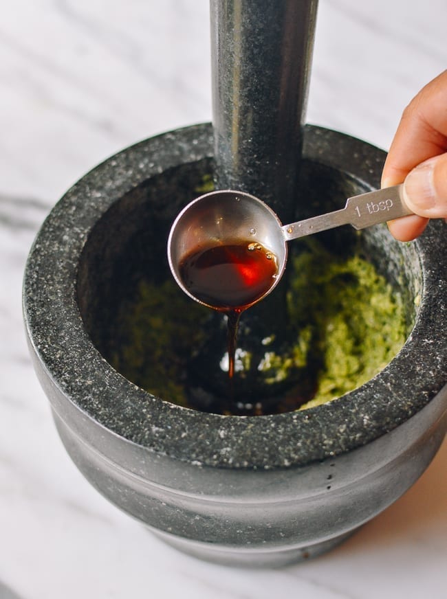 Adding other marinade ingredients to mortar and pestle, thewoksoflife.com