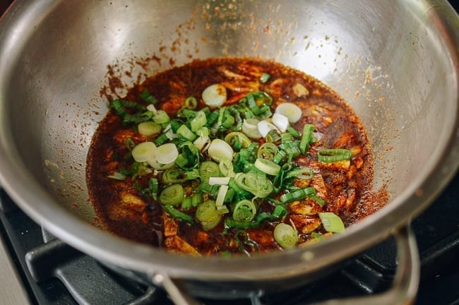 Adding scallions to garlic noodle sauce, thewoksoflife.com