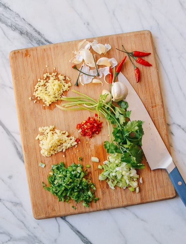 Chopping aromatics on cutting board, thewoksoflife.com
