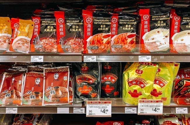 Different varieties of hot pot soup base on store shelves, thewoksoflife.com