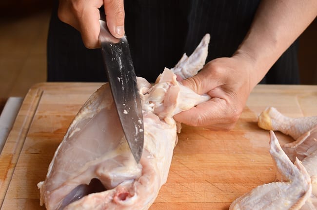 slicing through chicken wing joint