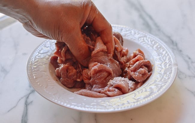 Massaging marinade ingredients into pork, thewoksoflife.com