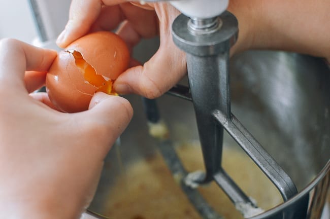 Adding eggs to creamed butter, sugar, and oil, thewoksoflife.com