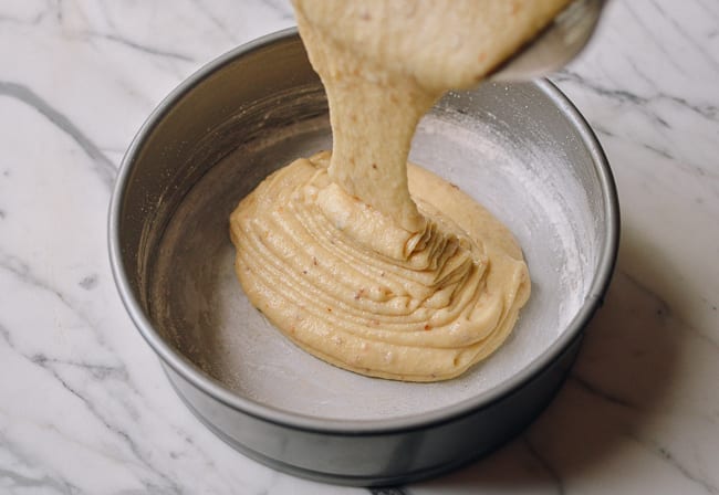 Pouring cake batter into greased and floured springform pan, thewoksoflife.com