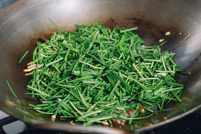 Adding garlic chives to wok, thewoksoflife.com