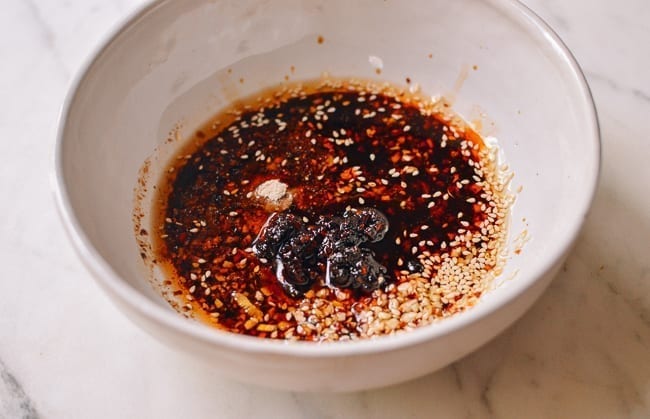 Stirring in other broth ingredients, thewoksoflife.com