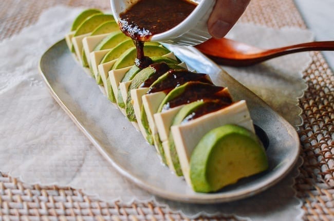 Drizzling sauce over tofu and avocado, thewoksoflife.com