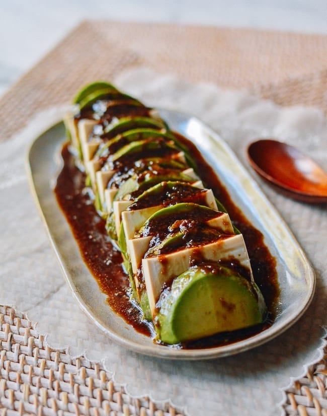 Tofu and avocado with dressing on top, thewoksoflife.com