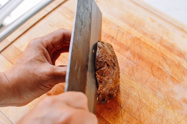 Slicing beef shank in half lengthwise, thewoksoflife.com