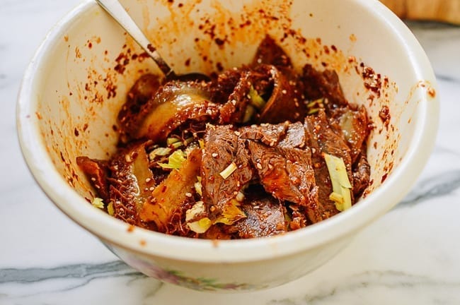 Tossing fuqi feipian in sauce, thewoksoflife.com