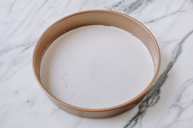 Thin layer of batter in cake pan, thewoksoflife.com